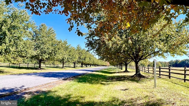 surrounding community with a rural view and a lawn