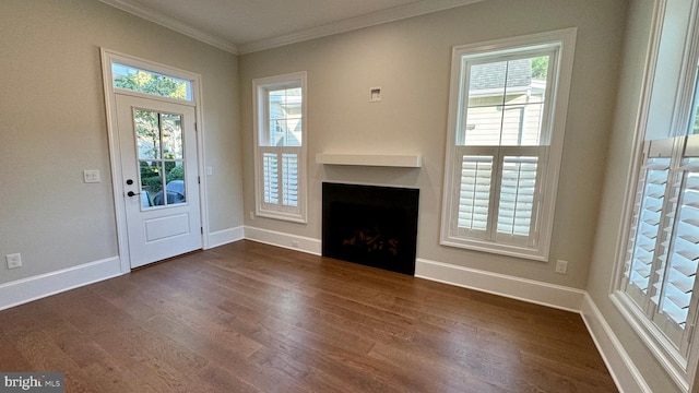 unfurnished living room with dark wood-type flooring and ornamental molding