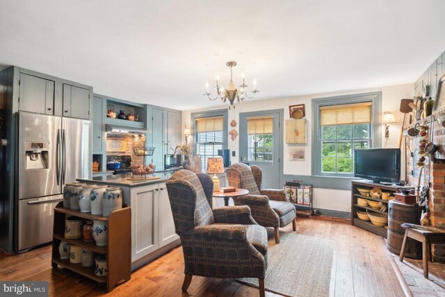 living room with an inviting chandelier and light hardwood / wood-style floors