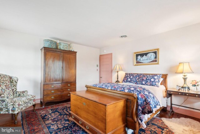 bedroom featuring dark wood-type flooring