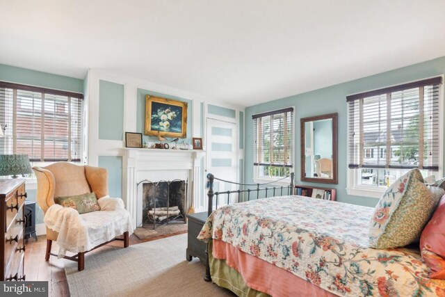 bedroom with light hardwood / wood-style flooring and multiple windows