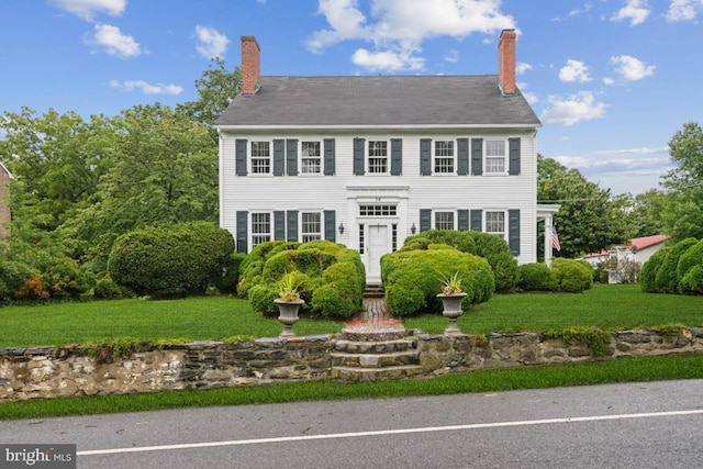 colonial-style house with a front yard