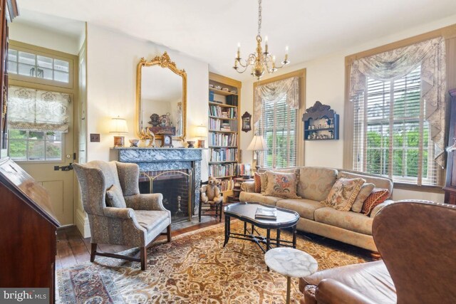 living room with plenty of natural light, a premium fireplace, and hardwood / wood-style flooring