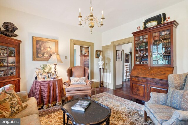 living room with a chandelier and dark hardwood / wood-style floors