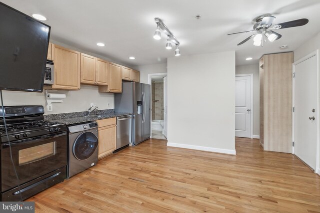 kitchen featuring dark countertops, light brown cabinets, washer / clothes dryer, and stainless steel appliances