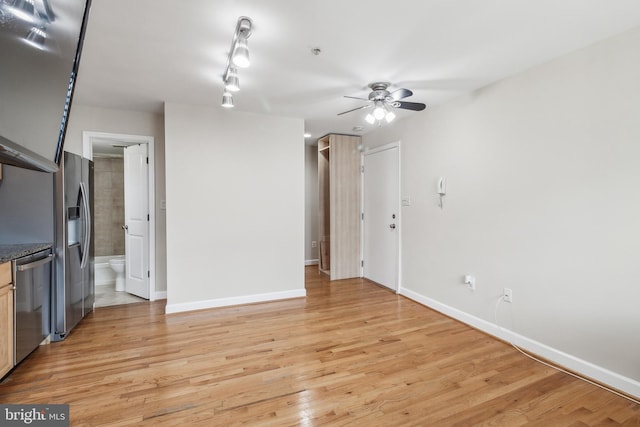 unfurnished living room featuring light wood-style floors, ceiling fan, and baseboards