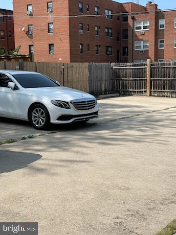 view of parking featuring fence