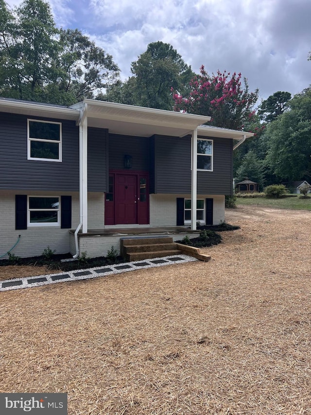 split foyer home featuring brick siding