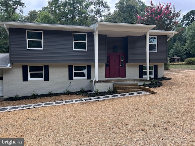 bi-level home featuring brick siding