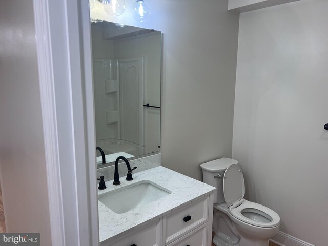 bathroom with toilet and vanity