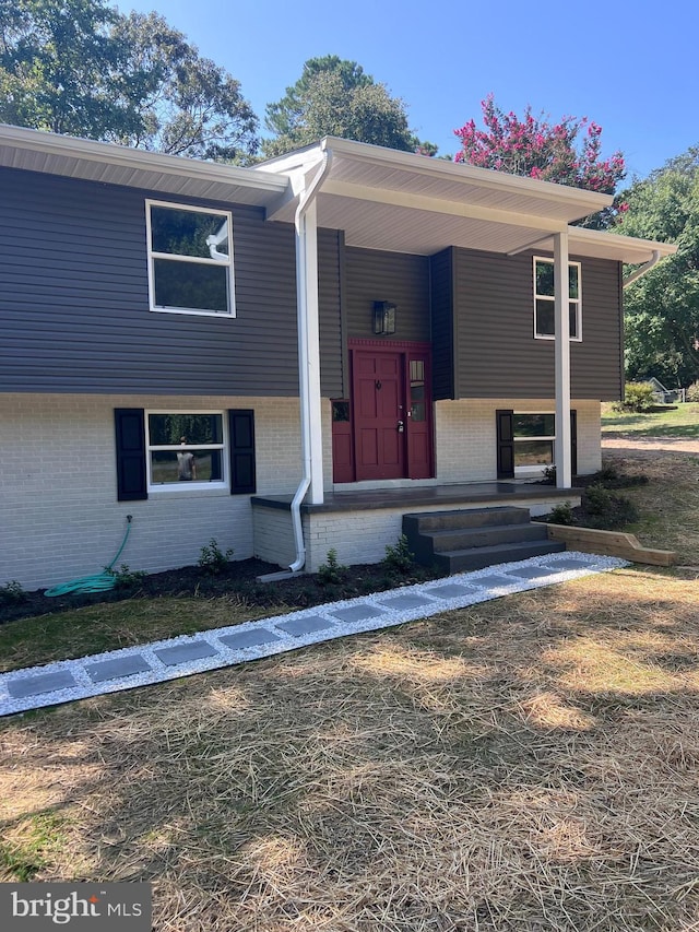 bi-level home featuring brick siding