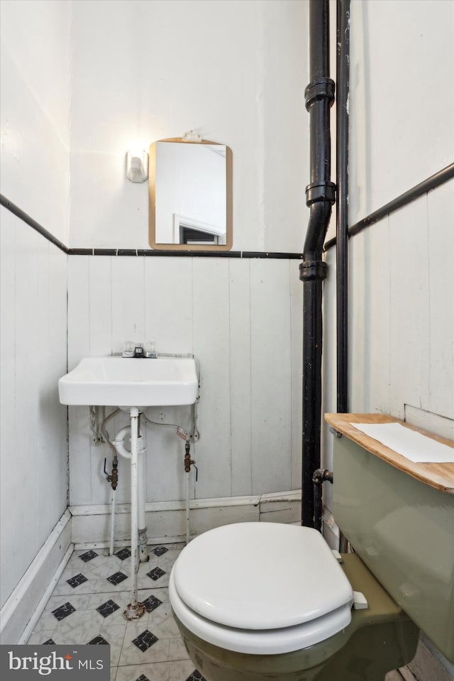 bathroom with tile patterned flooring and toilet