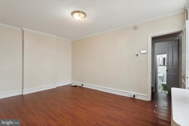 empty room featuring ornamental molding and wood-type flooring