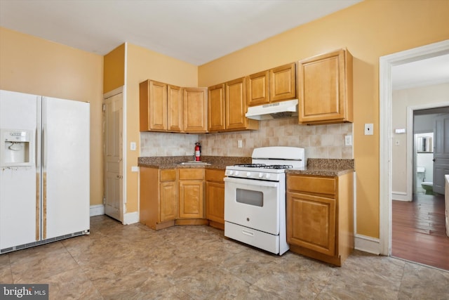 kitchen featuring sink, decorative backsplash, light tile patterned flooring, and white appliances