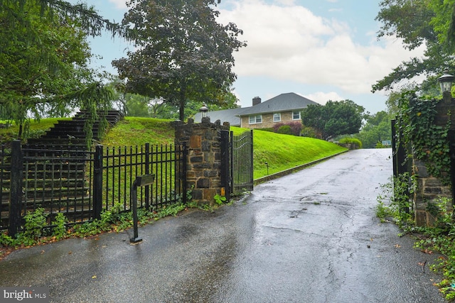 view of gate featuring a yard