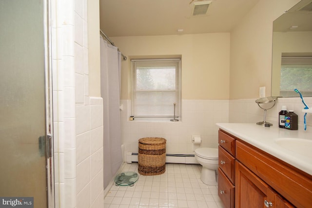 bathroom featuring baseboard heating, toilet, tile walls, tile patterned floors, and vanity