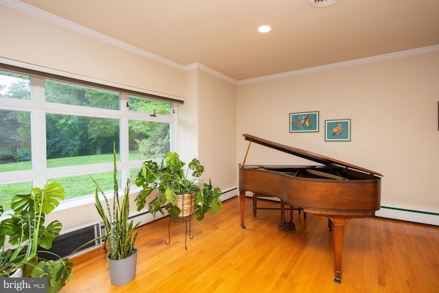 miscellaneous room with crown molding, baseboard heating, and light hardwood / wood-style floors