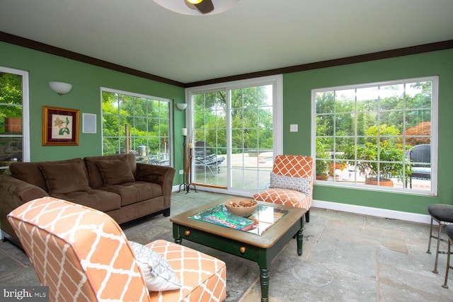 living room with crown molding and a healthy amount of sunlight