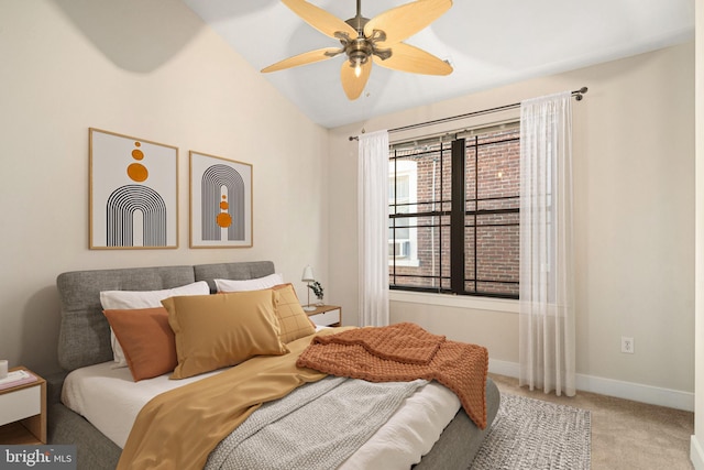 carpeted bedroom featuring lofted ceiling and ceiling fan