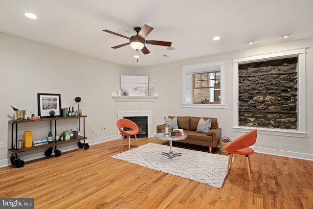 living room with ceiling fan and light hardwood / wood-style floors