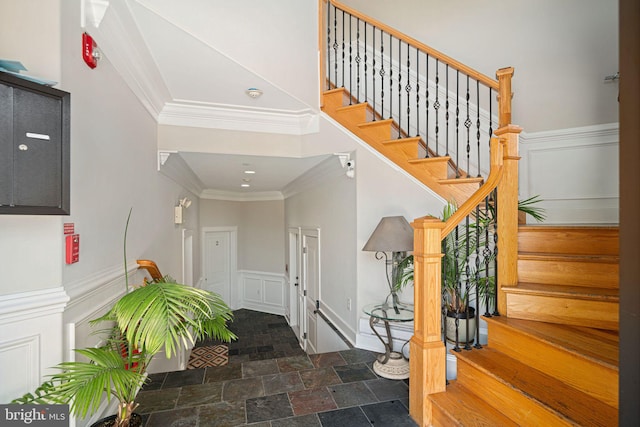 interior space featuring crown molding and a high ceiling