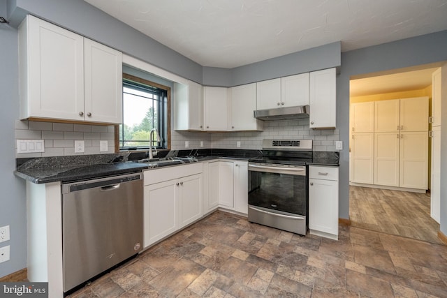 kitchen with sink, stainless steel appliances, tasteful backsplash, and white cabinets