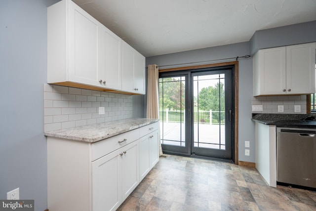 kitchen with white cabinetry, backsplash, light stone countertops, and dishwasher