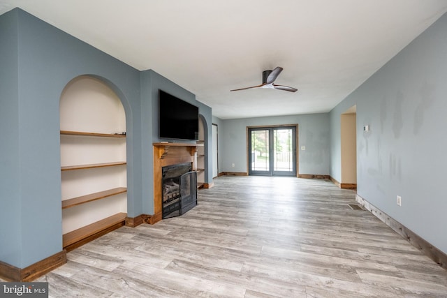 unfurnished living room with ceiling fan and light hardwood / wood-style floors