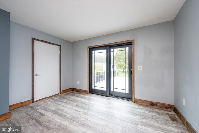 empty room with light hardwood / wood-style flooring