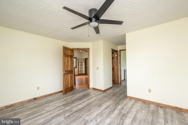 interior space featuring a textured ceiling, ceiling fan, and hardwood / wood-style flooring