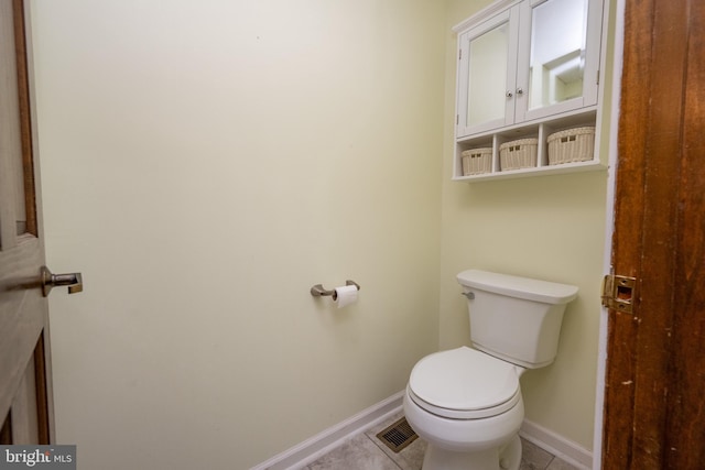 bathroom with toilet and tile patterned floors