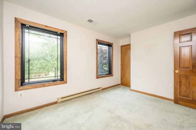 empty room with light colored carpet and baseboard heating