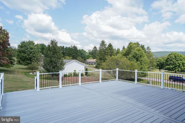 wooden terrace with a lawn