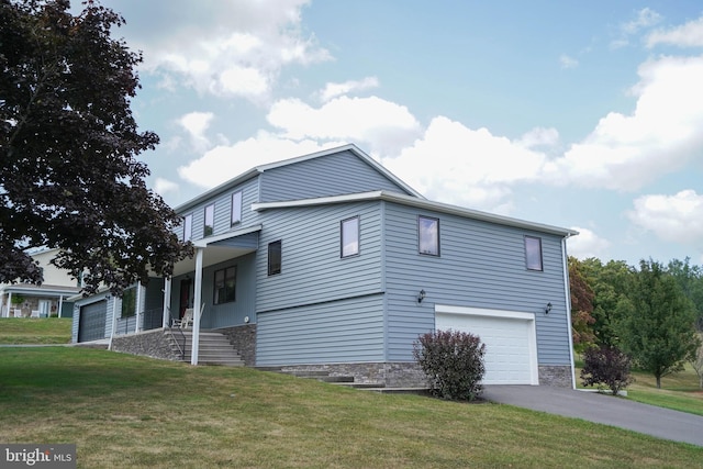 view of side of property with a porch, a garage, and a yard