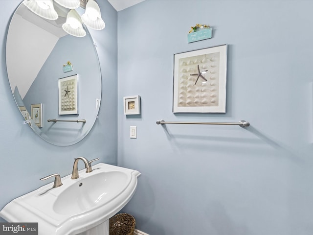 bathroom featuring vaulted ceiling and sink