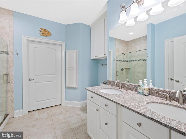 bathroom featuring tile patterned flooring, vanity, and an enclosed shower