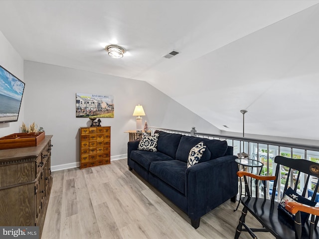 living room with lofted ceiling and light wood-type flooring