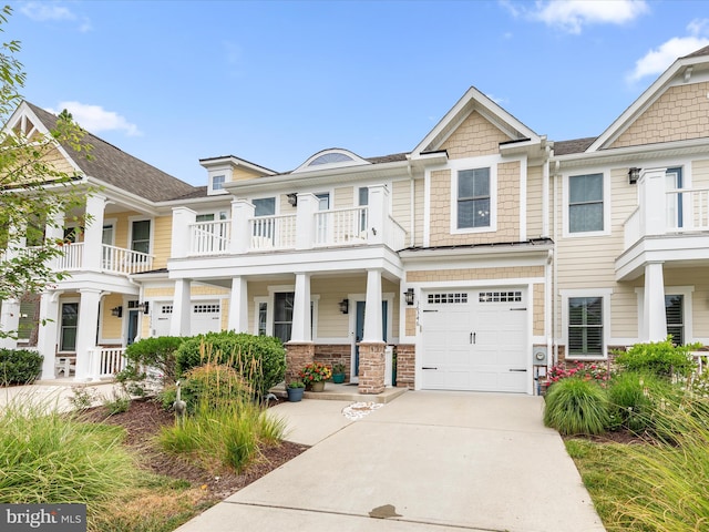 multi unit property featuring a porch, a balcony, and a garage