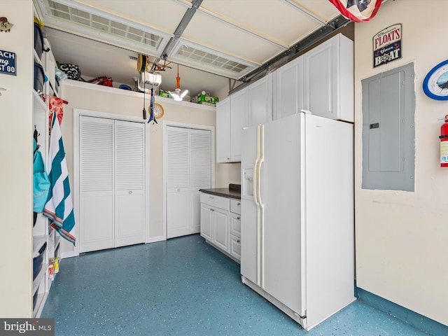 garage with white refrigerator with ice dispenser, electric panel, and a garage door opener