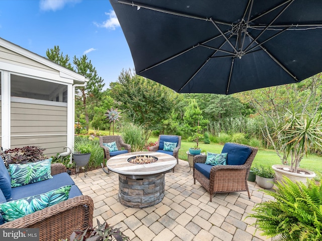 view of patio featuring an outdoor living space with a fire pit