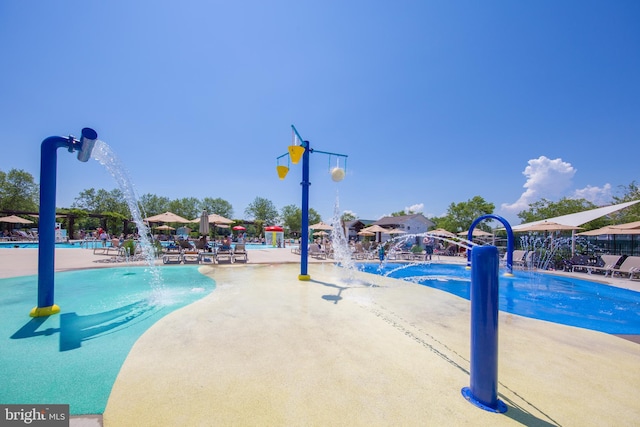 view of pool with pool water feature