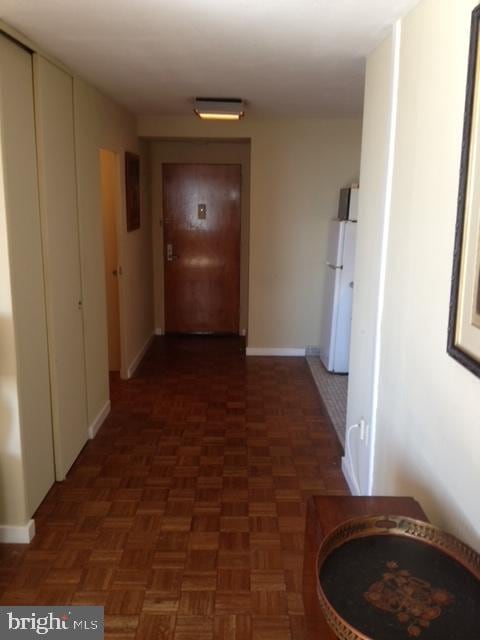 corridor featuring parquet flooring