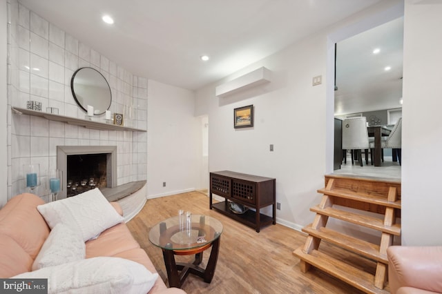 living room with a fireplace and light wood-type flooring