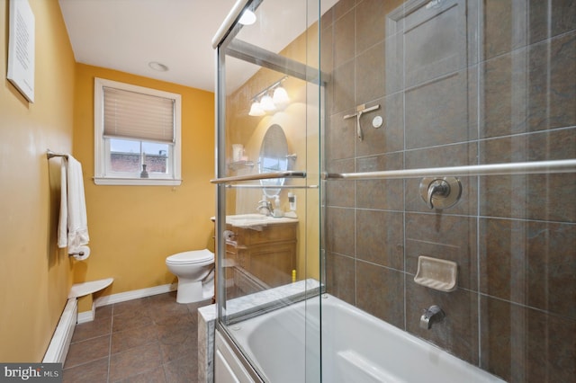 full bathroom featuring vanity, tile patterned floors, toilet, and combined bath / shower with glass door