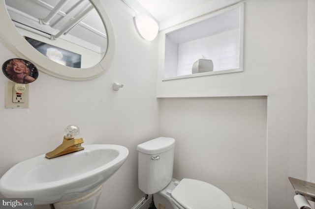 bathroom featuring sink and toilet