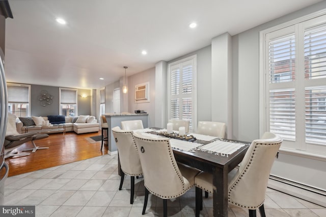 tiled dining area with a baseboard radiator