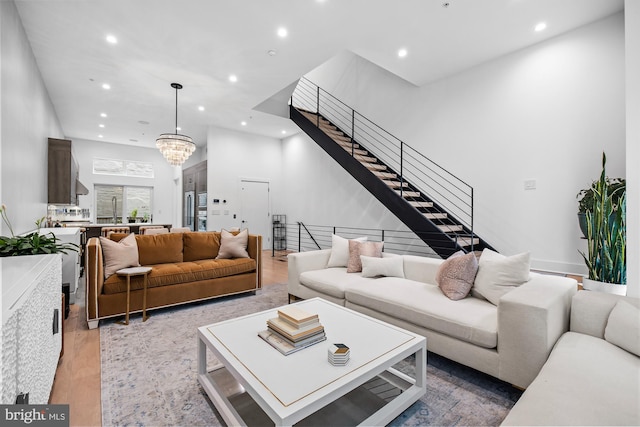 living room featuring a notable chandelier and light wood-type flooring