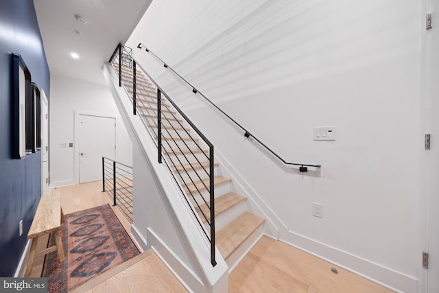 staircase with light hardwood / wood-style floors