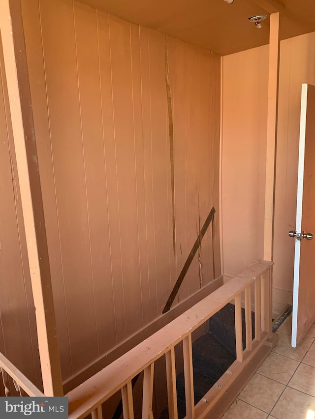 stairway featuring light tile patterned floors