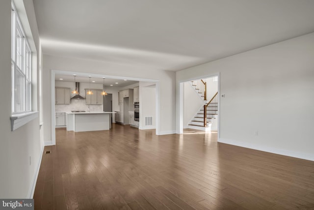 unfurnished living room featuring dark wood-type flooring